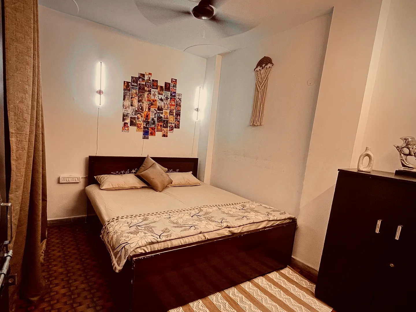 Primary bedroom with king bed and Bollywood artwork