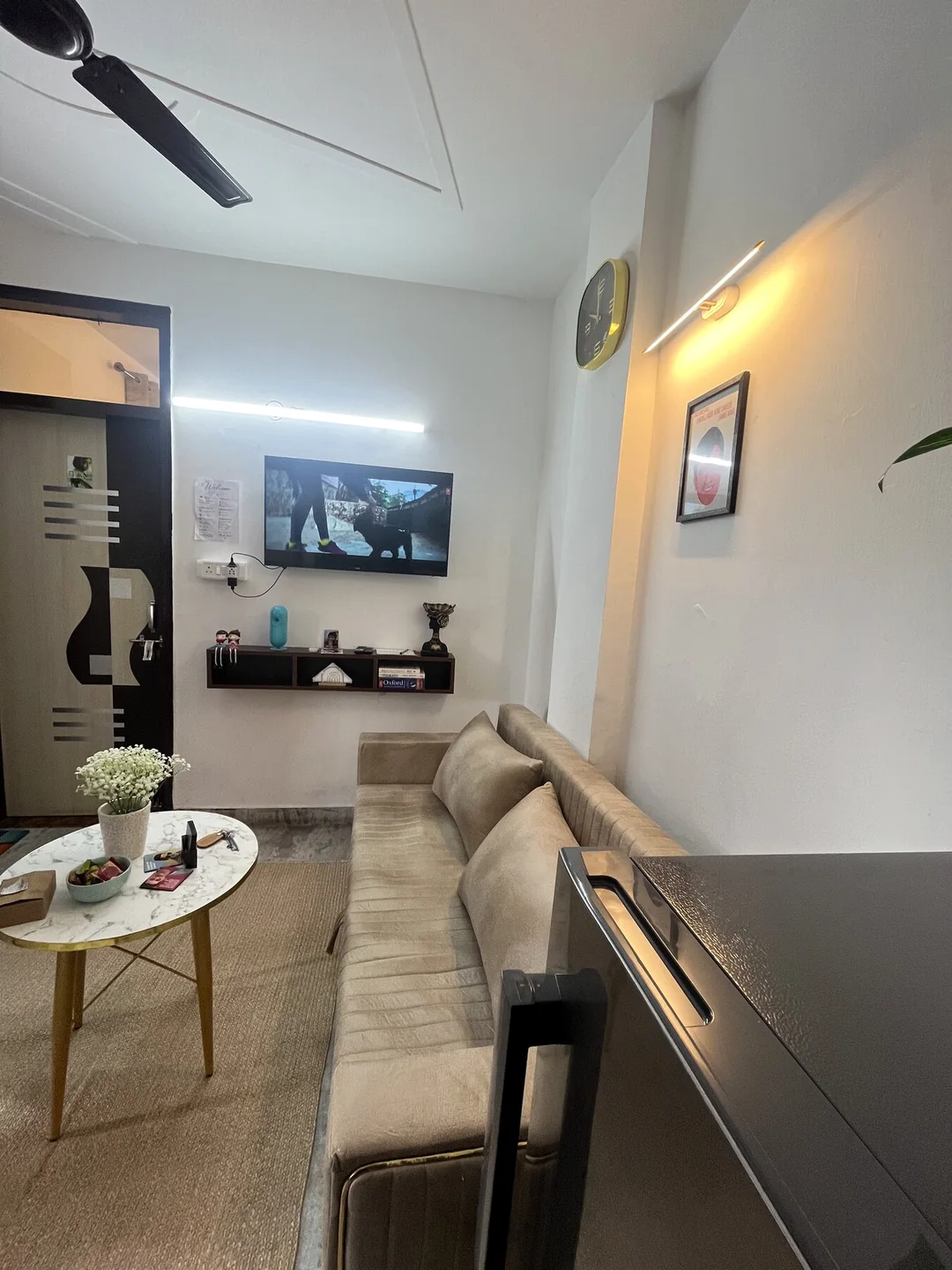 Wide-angle living area with sofa, television and dining table