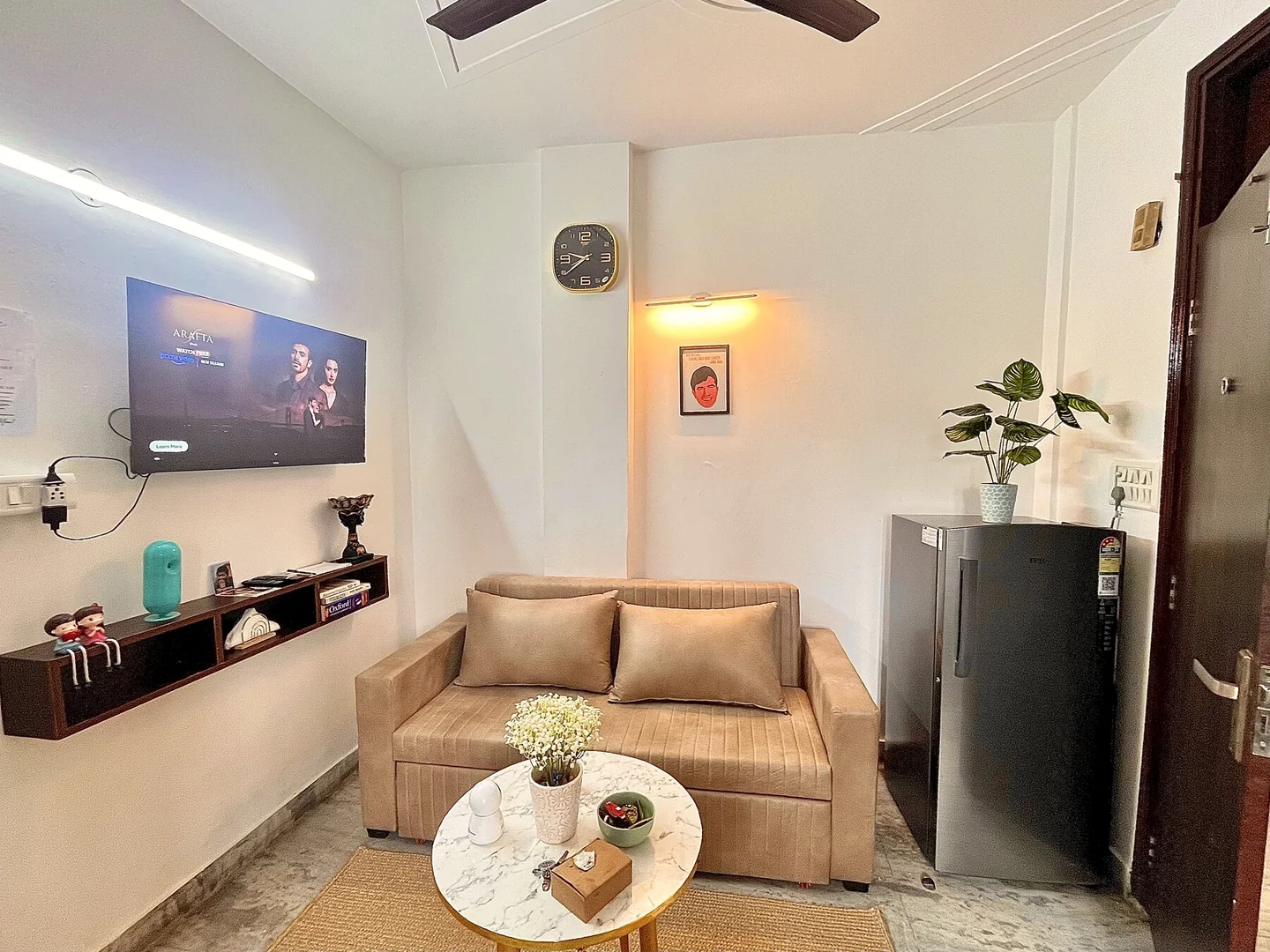 Wide view of the Urban Serenity living room with smart TV and warm seating